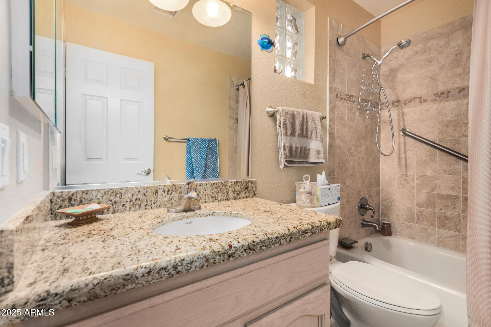 15531 Piccadilly Road Goodyear, AZ 85395 - Photo 30 of 54 a bathroom with a granite countertop tub sink and toilet