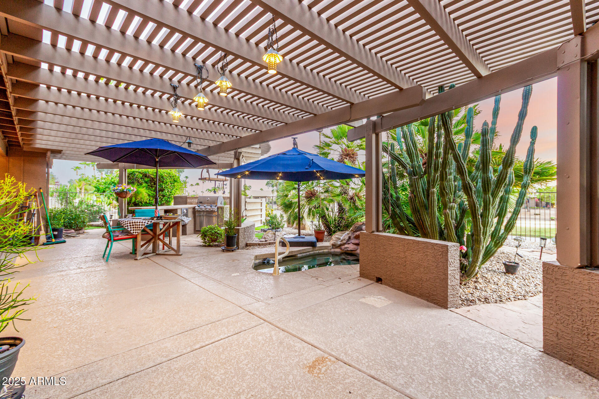 15531 Piccadilly Road Goodyear, AZ 85395 - Photo 38 of 54 a view of patio with a table and chairs under an umbrella with a patio