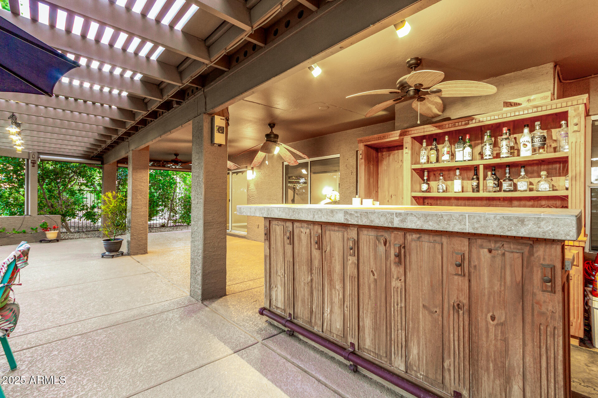 15531 Piccadilly Road Goodyear, AZ 85395 - Photo 40 of 54 a view of a porch with a table and chairs