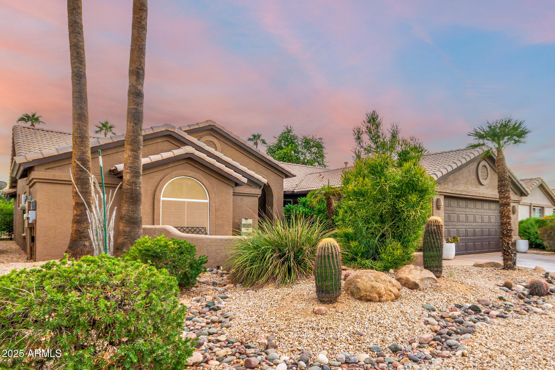 15531 Piccadilly Road Goodyear, AZ 85395 - Photo 4 of 54 a front view of a house with a garden