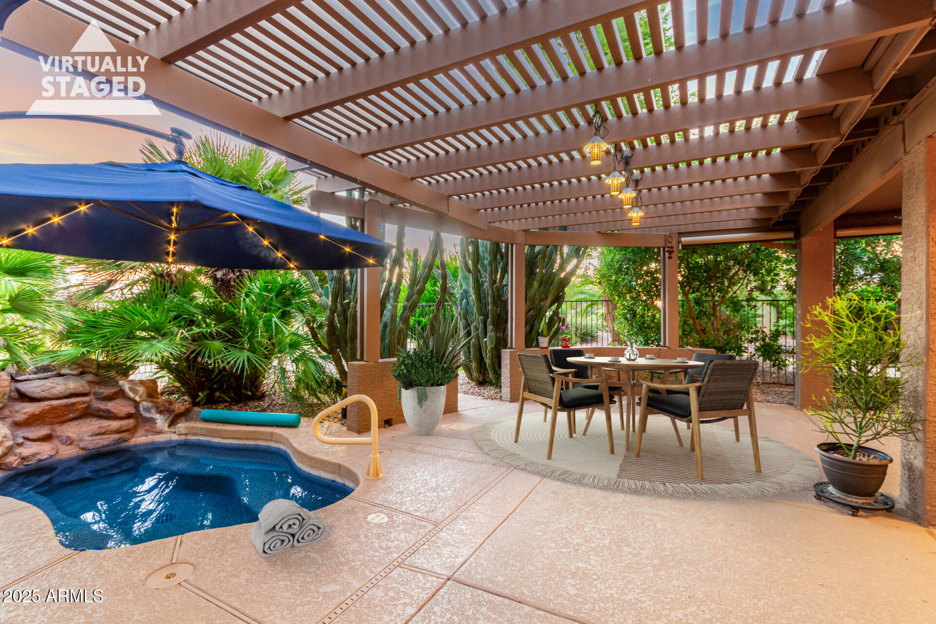 15531 Piccadilly Road Goodyear, AZ 85395 - Photo 42 of 54 a view of a patio with table and chairs potted plants and floor to ceiling window