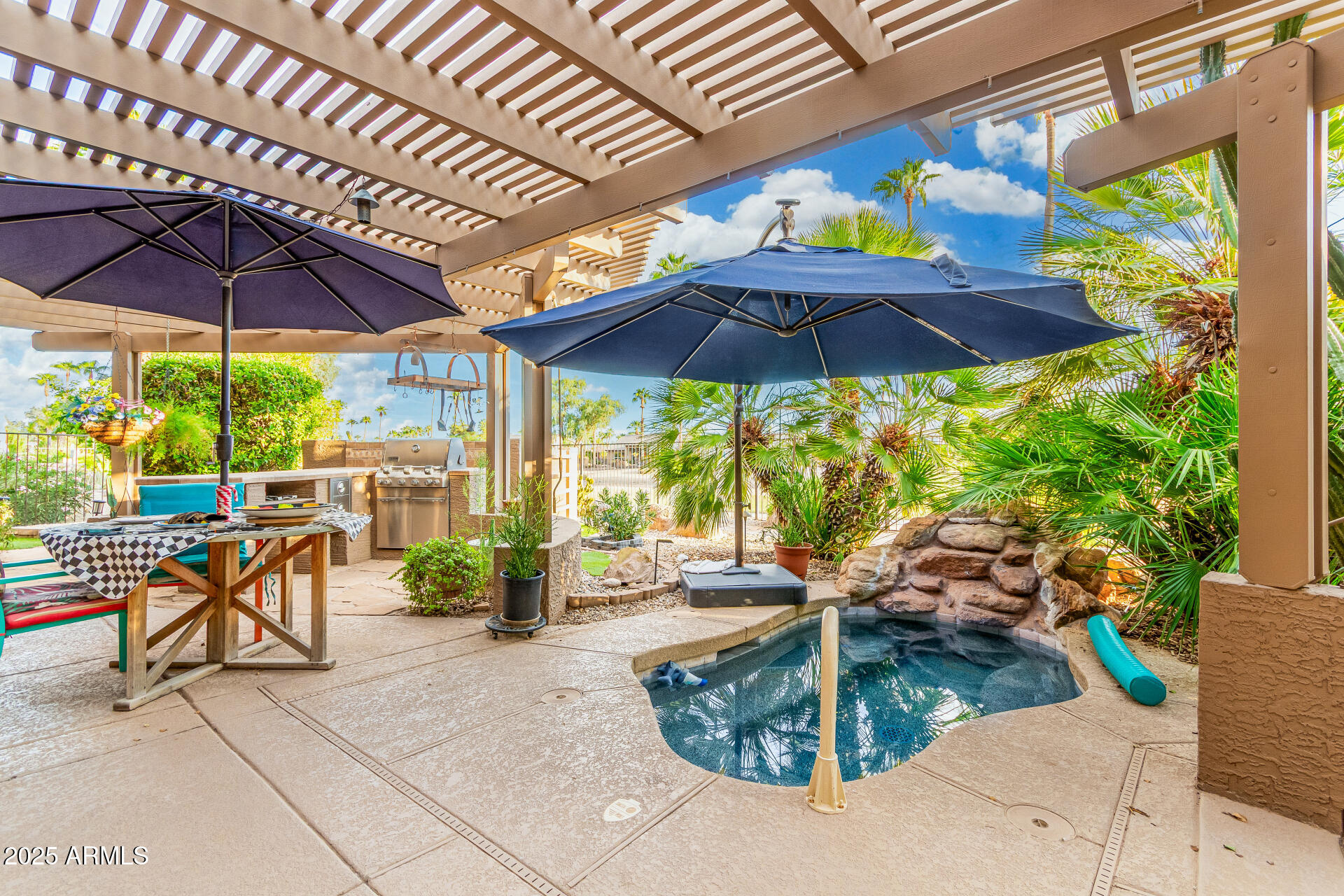 15531 Piccadilly Road Goodyear, AZ 85395 - Photo 46 of 54 a view of a patio with a table and chairs under an umbrella