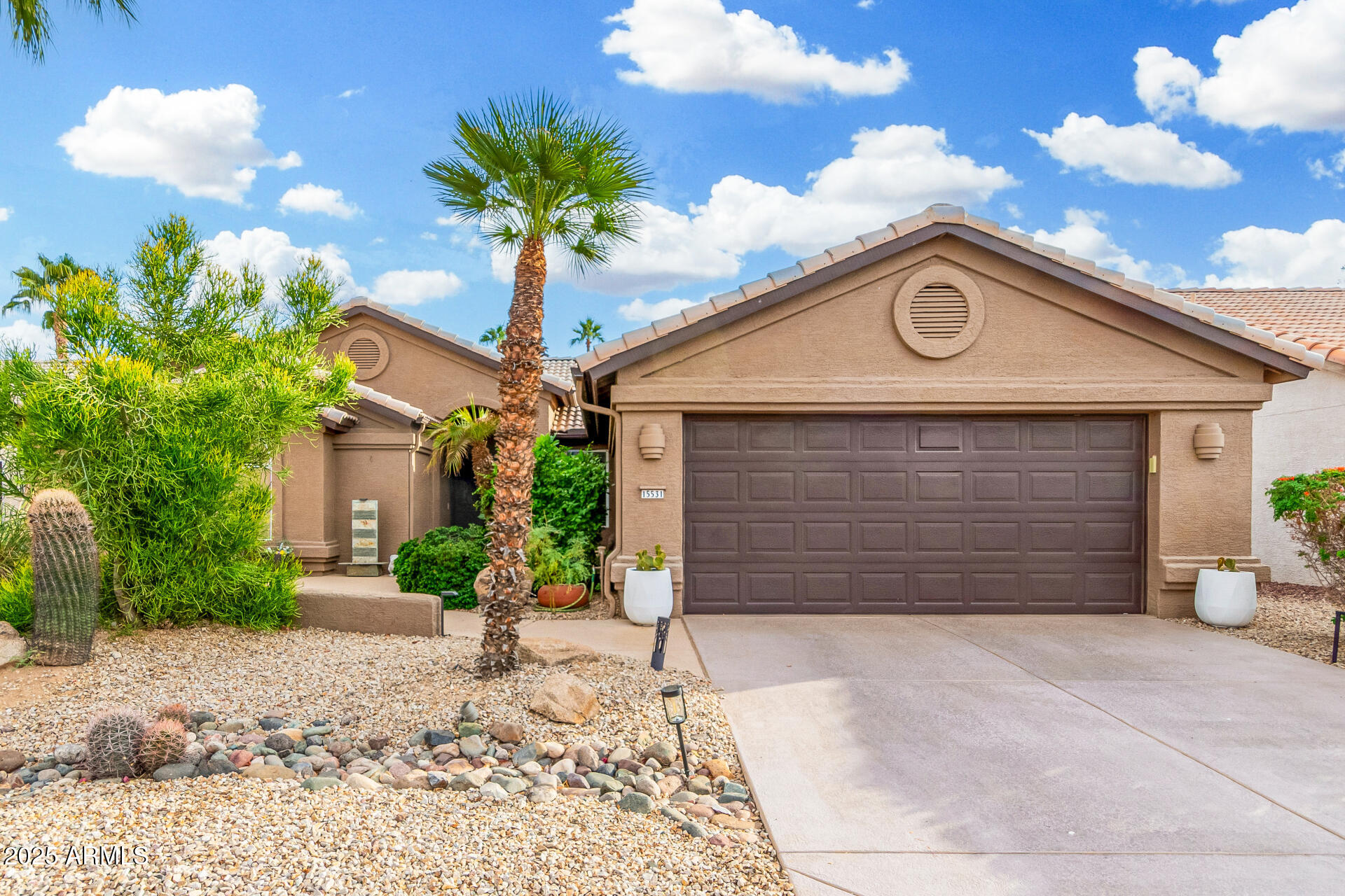 15531 Piccadilly Road Goodyear, AZ 85395 - Photo 8 of 54 a front view of a house with garden