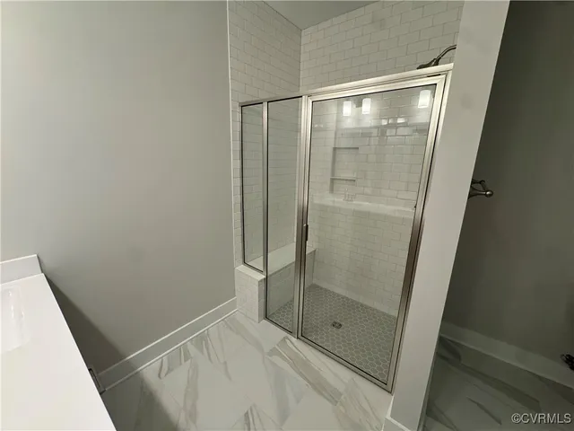 a bathroom with a glass shower door