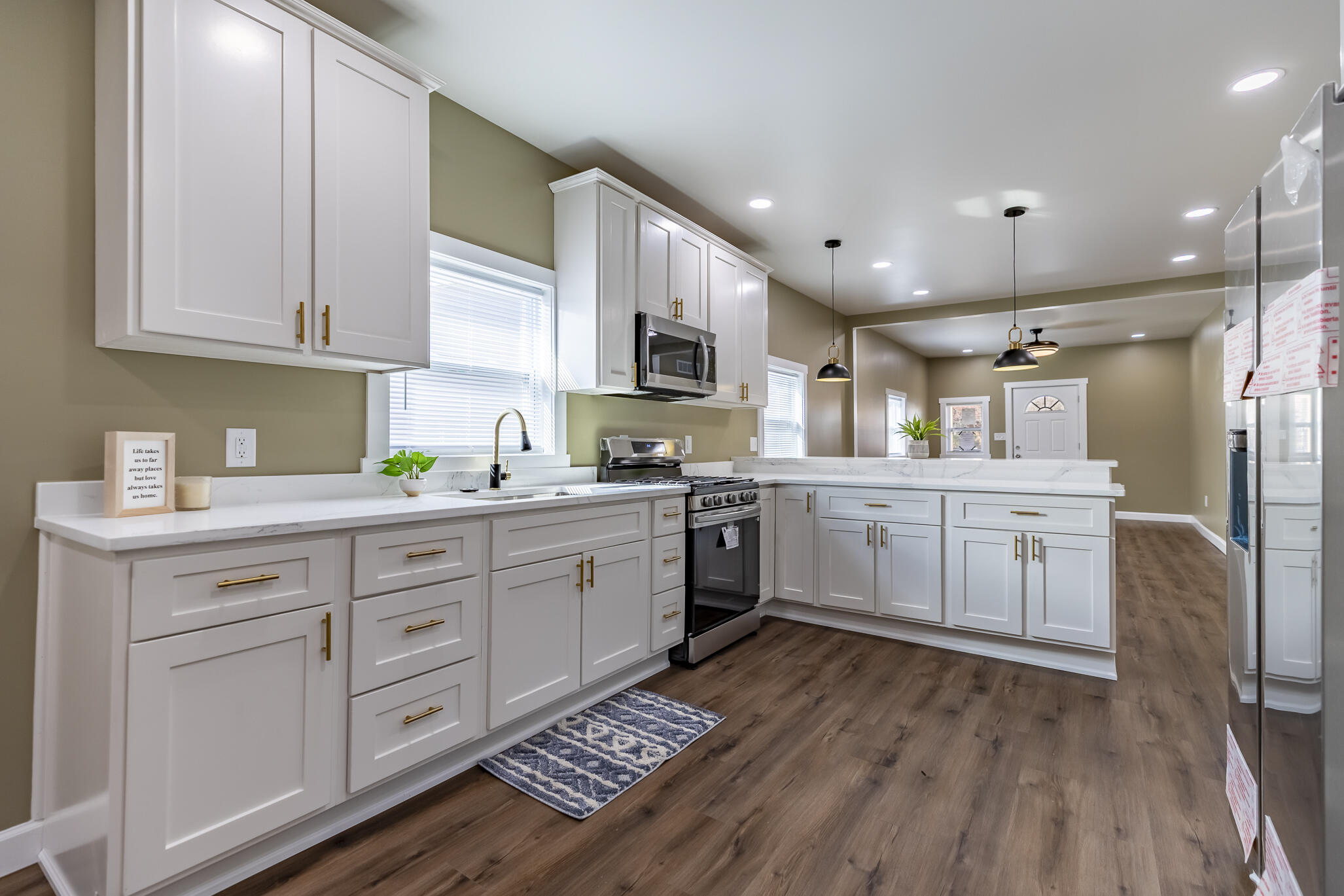 1047 Arizona Street Gary, IN 46403 - Photo 12 of 35 a kitchen with kitchen island granite countertop a sink cabinets and stainless steel appliances