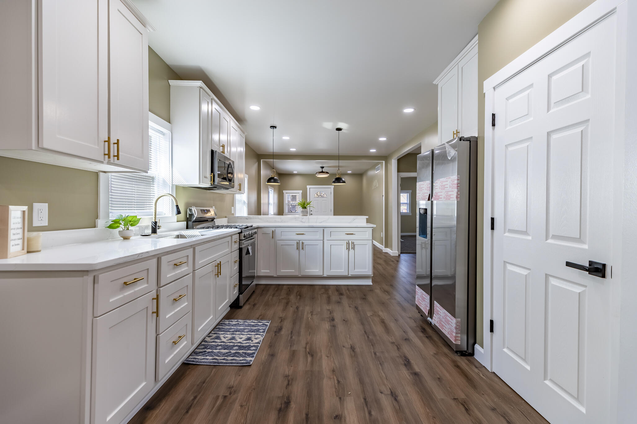 1047 Arizona Street Gary, IN 46403 - Photo 13 of 35 a kitchen with cabinets a sink and wooden floor