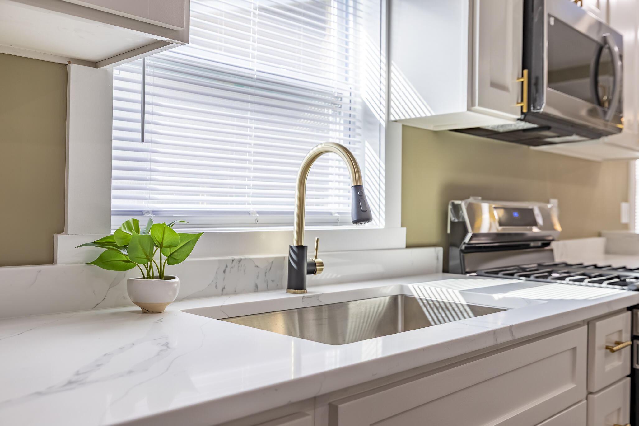 1047 Arizona Street Gary, IN 46403 - Photo 15 of 35 a view of a kitchen area with a sink and potted plant