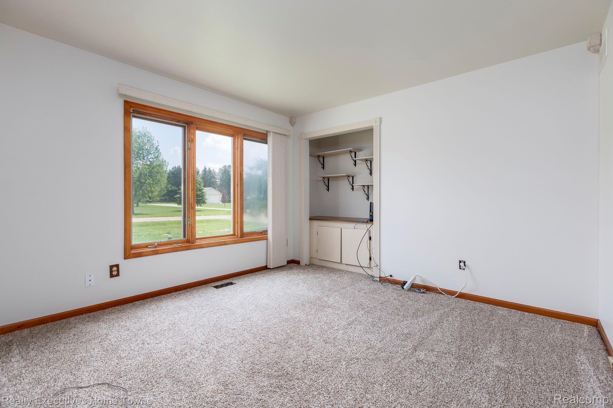 1041 Mackie Road Almont, MI 48003 - Photo 42 of 56 Empty room with baseboards and carpet floors