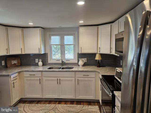 a kitchen with a sink window and cabinets
