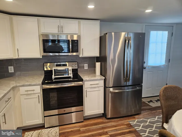 a kitchen with a stove microwave and refrigerator