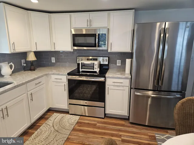 a kitchen with a refrigerator stove and microwave