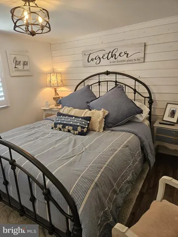a bedroom with a bed that has a blanket on it