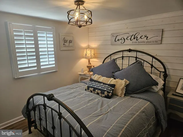 a bedroom with a bed and a dresser in it