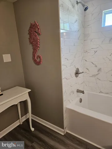 a bathroom with a bathtub and shower