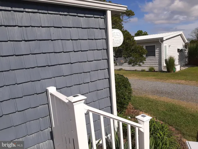 a view of a small yard and wooden fence
