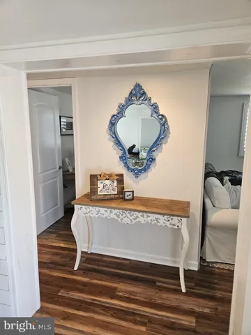 a view of a hallway view with wooden floor and staircase