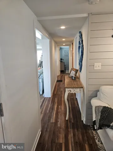 a view of a room with wooden floor and furniture