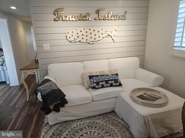 a white couch sitting in a bathroom next to a window