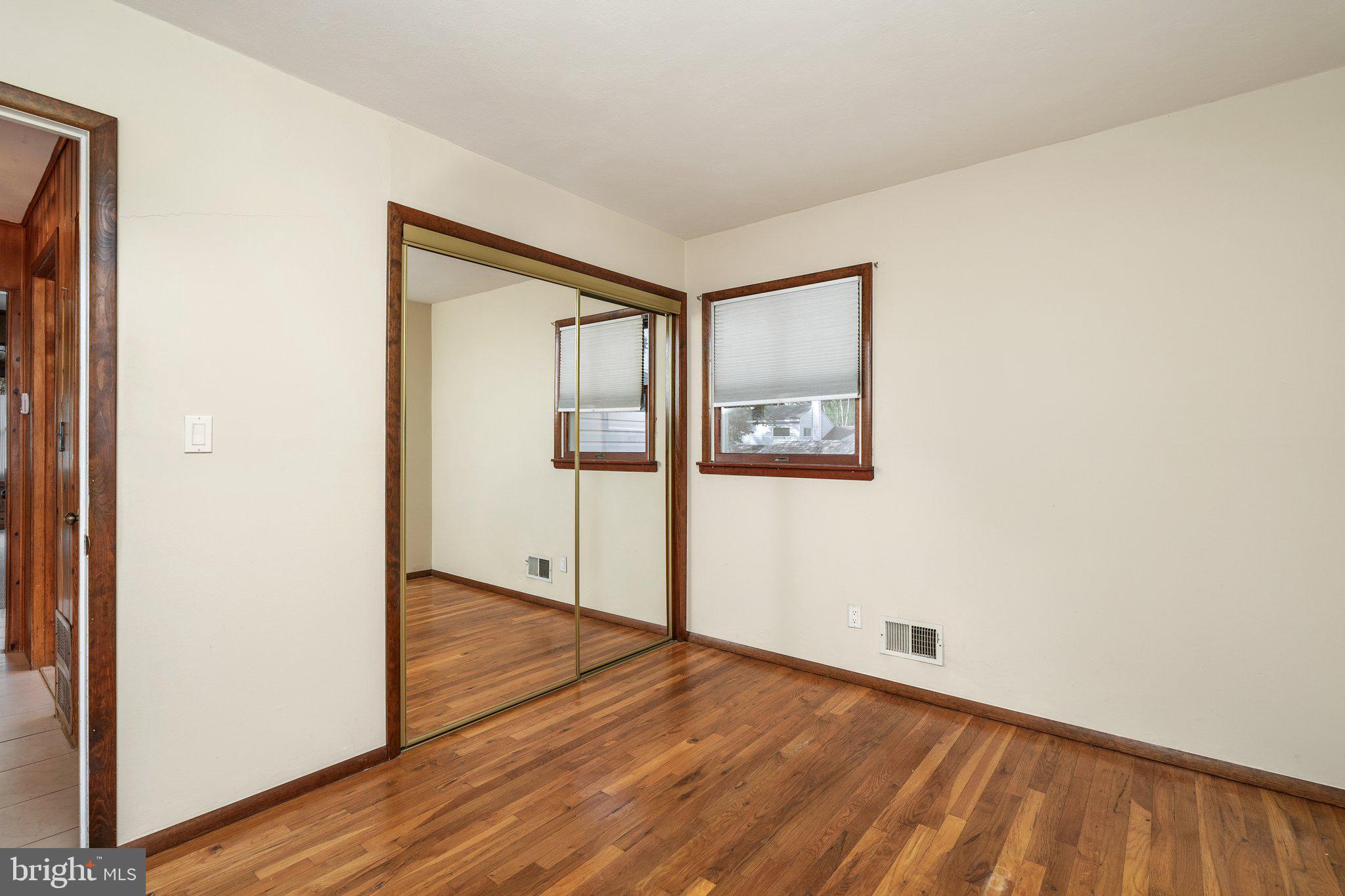 44 Falmouth Road Hamilton, NJ 08620 - Photo 15 of 27 an empty room with wooden floor and windows
