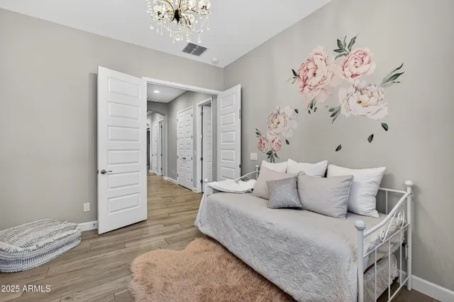 a view of a house with a yard and large tree