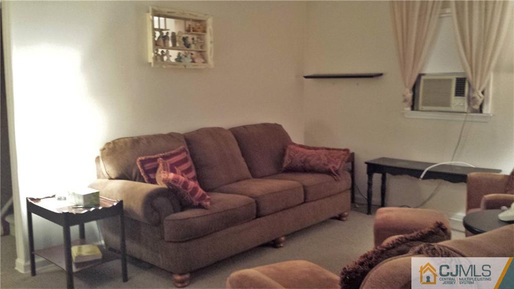8 Longfield Road New Brunswick, NJ 08901 - Photo 3 of 8 a living room with furniture and a window