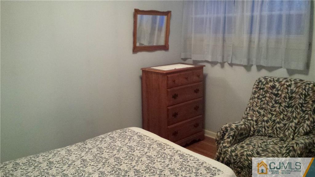 8 Longfield Road New Brunswick, NJ 08901 - Photo 8 of 8 a bedroom with a bed and a dresser