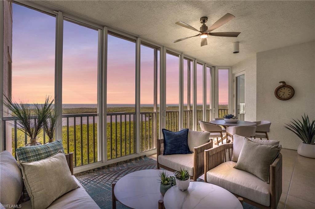 265 Indies Way, Unit 1404 Naples, FL 34110 - Photo 2 of 42 Sunroom featuring plenty of natural light, a water view, and ceiling fan