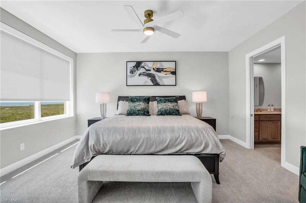 265 Indies Way, Unit 1404 Naples, FL 34110 - Photo 26 of 42 Carpeted bedroom featuring ceiling fan and connected bathroom