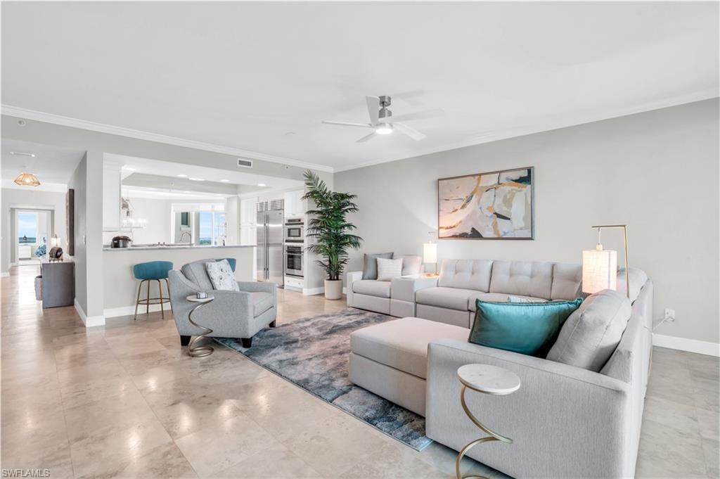 265 Indies Way, Unit 1404 Naples, FL 34110 - Photo 5 of 42 Living room with ornamental molding, light tile patterned floors, and ceiling fan