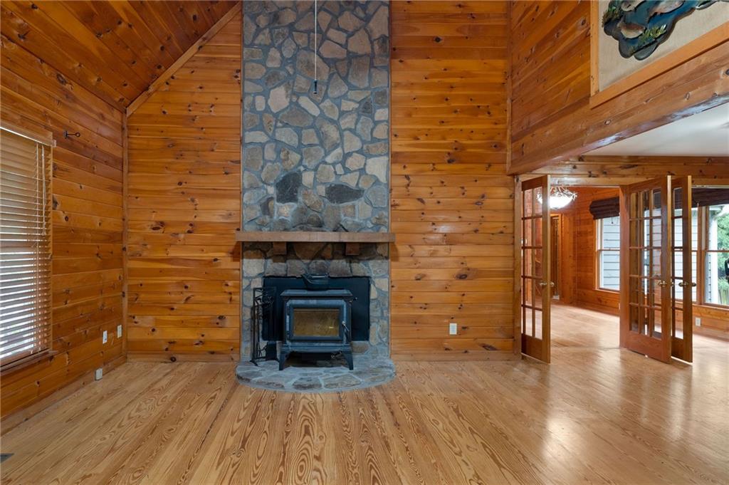 442 Cartecay River Run Ellijay, GA 30536 - Photo 14 of 63 a view of empty room with wooden floor and fireplace