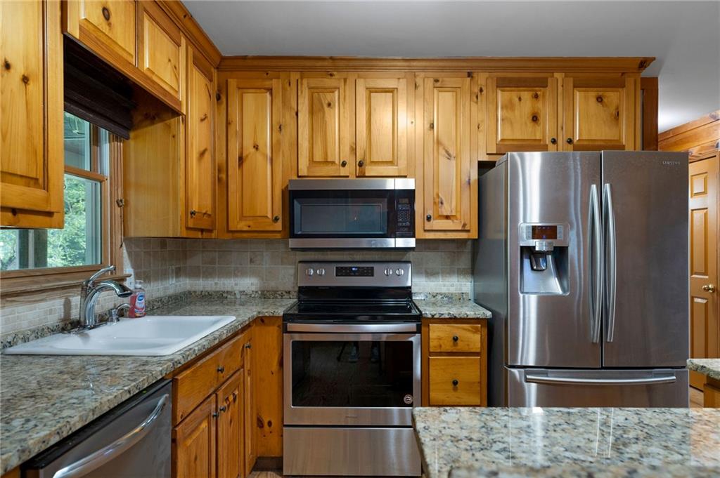 442 Cartecay River Run Ellijay, GA 30536 - Photo 19 of 63 a kitchen with stainless steel appliances granite countertop a stove refrigerator and microwave