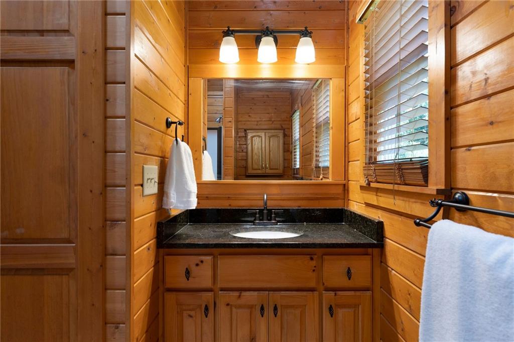442 Cartecay River Run Ellijay, GA 30536 - Photo 26 of 63 a bathroom with a granite countertop sink and a window