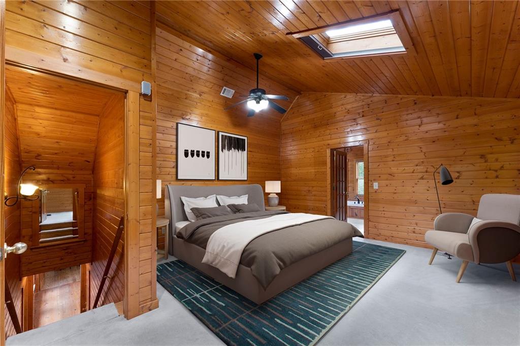 442 Cartecay River Run Ellijay, GA 30536 - Photo 30 of 63 a bedroom with a bed and a couch