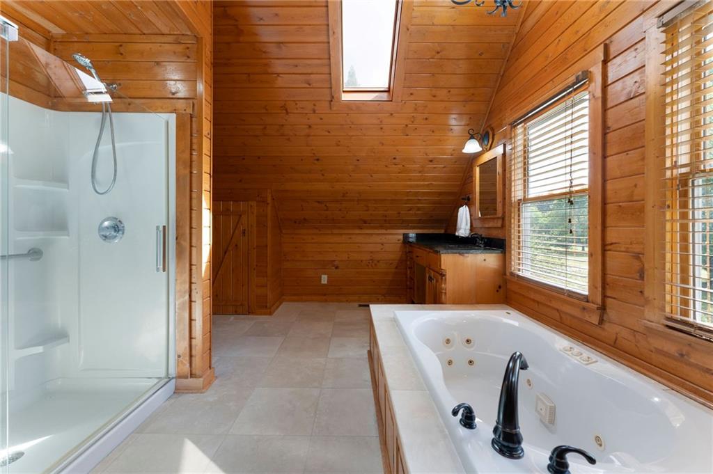 442 Cartecay River Run Ellijay, GA 30536 - Photo 32 of 63 a bathroom with a tub and a shower