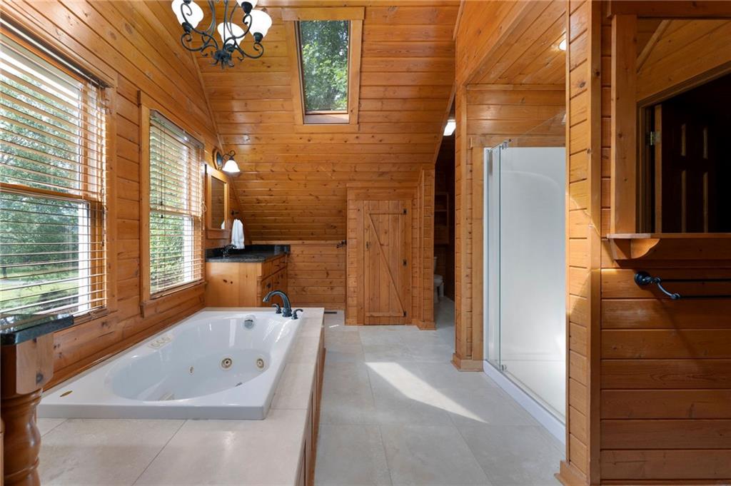 442 Cartecay River Run Ellijay, GA 30536 - Photo 34 of 63 a bathroom with a bathtub and shower