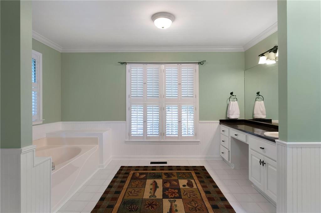 442 Cartecay River Run Ellijay, GA 30536 - Photo 43 of 63 a bathroom with a granite countertop sink a large mirror and a bathtub