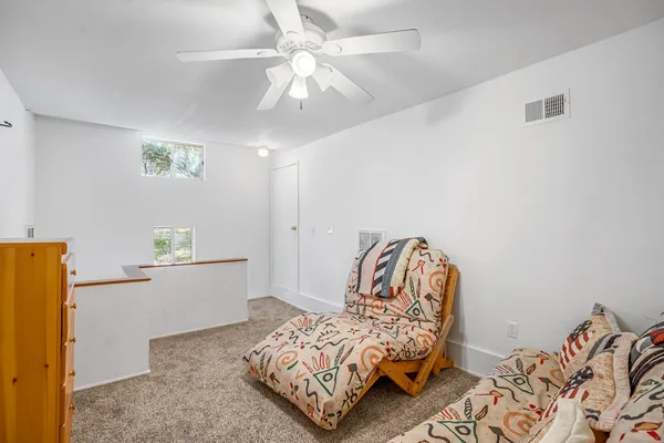 a bedroom with bed and a chandelier