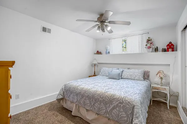 a bedroom with a large bed and a chandelier