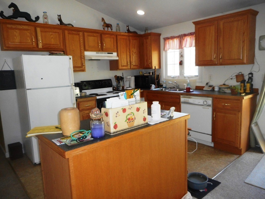200 West Orange Road Orange, MA 01364 - Photo 19 of 24 a kitchen with stainless steel appliances granite countertop a stove top oven a sink a refrigerator and white cabinets