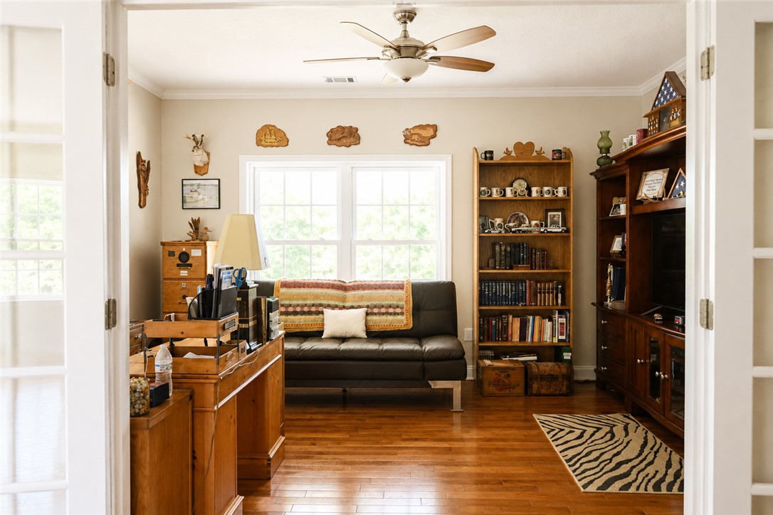 190 Fred Bradford Road Iva, SC 29655 - Photo 23 of 32 This versatile room features warm wood flooring and ample natural light, ideal for both work and relaxation.