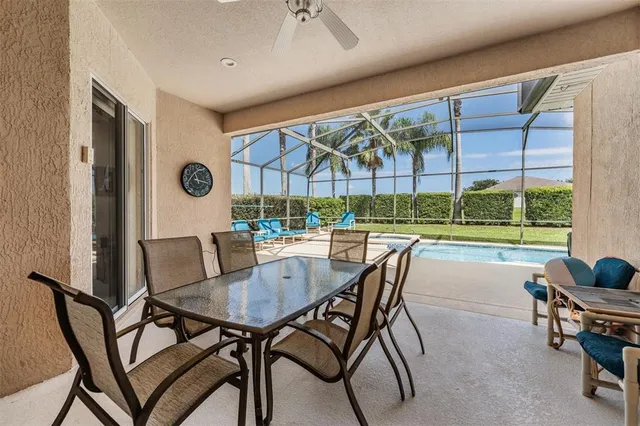 a dining room with furniture and a floor to ceiling window