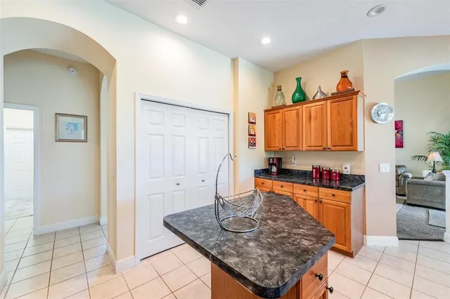 a kitchen with stainless steel appliances granite countertop a sink and a refrigerator
