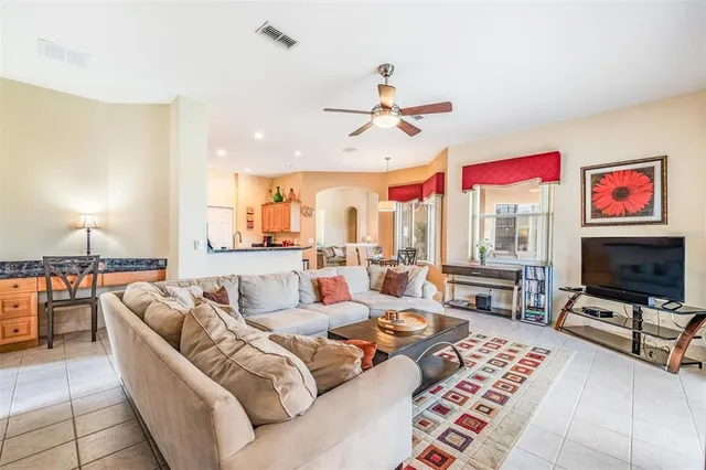 a living room with furniture a rug and a flat screen tv