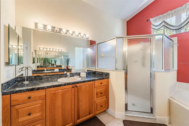 a bathroom with a granite countertop sink and a mirror