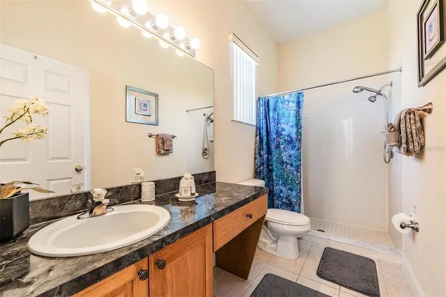 a bathroom with a double vanity sink toilet and shower