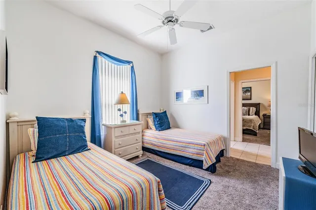 a bedroom with two beds and a tv