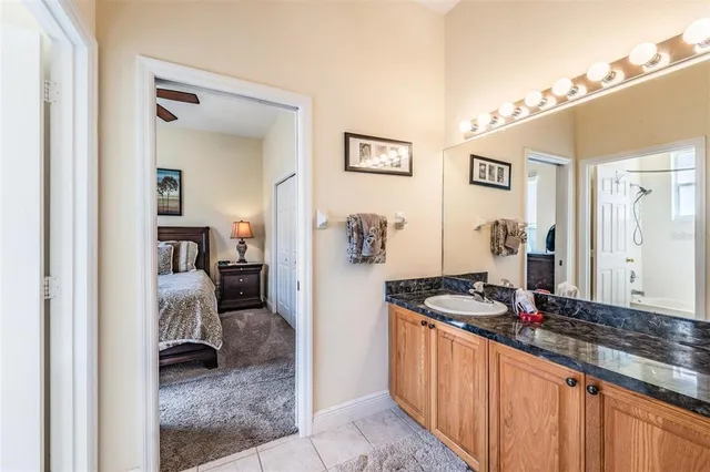 a hallway with a large mirror and a sink