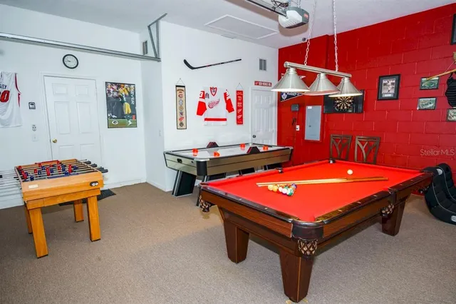 a room with pool table and wall paintings