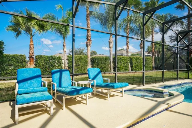 a view of a patio with table and chairs under an umbrella