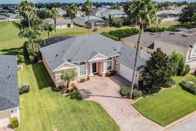 an aerial view of a house with swimming pool and garden